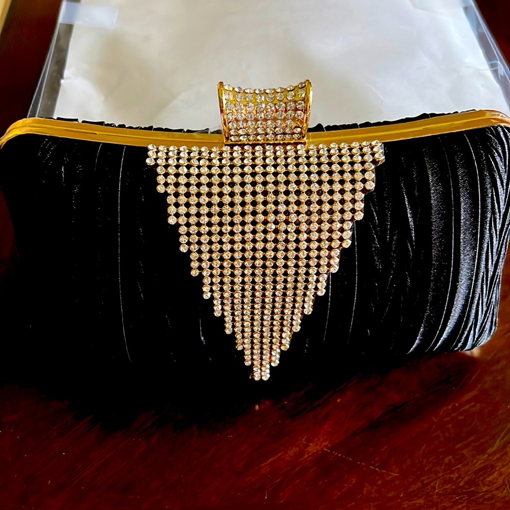 New never used black evening bag with gold accents and clear stones.
